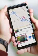 Person holding phone with gps tour app